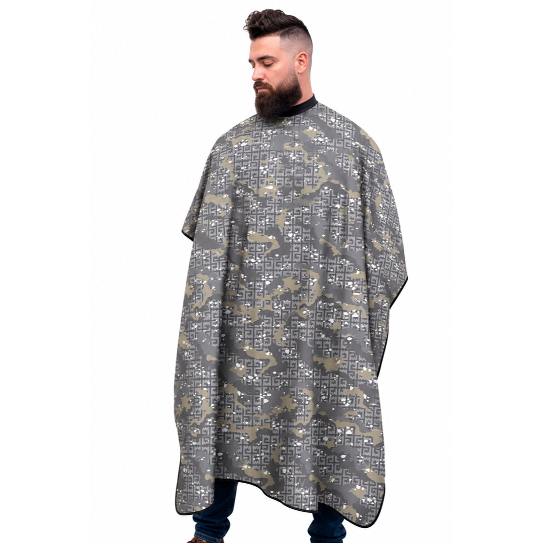 A man wearing a gray camo patterned barber cape on a solid white background.