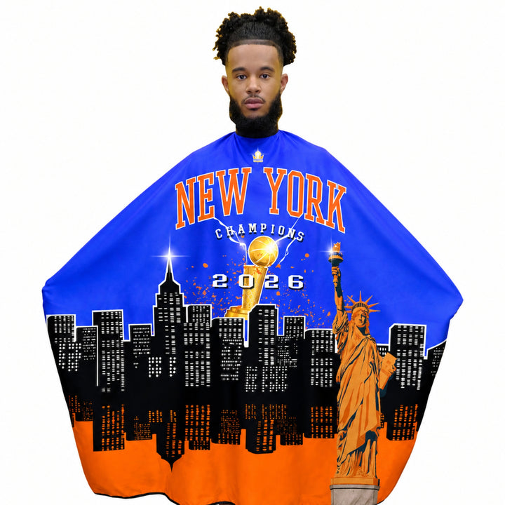 Man wearing a blue and orange Knicks barber cape with New York Champions 2026 design.