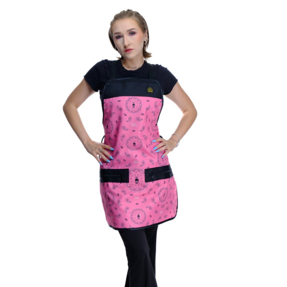 Person wearing  pink salon apron , Person wearing a pink bandana barber apron.