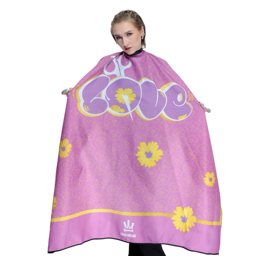 Person wearing a pink hairdressing cape with yellow floral patterns and text. Barber cape- barber capes- hairstylist cape - pink barber cape- pink salon cape