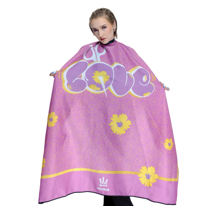 Person wearing a pink hairdressing cape with yellow floral patterns and text. Barber cape- barber capes- hairstylist cape - pink barber cape- pink salon cape
