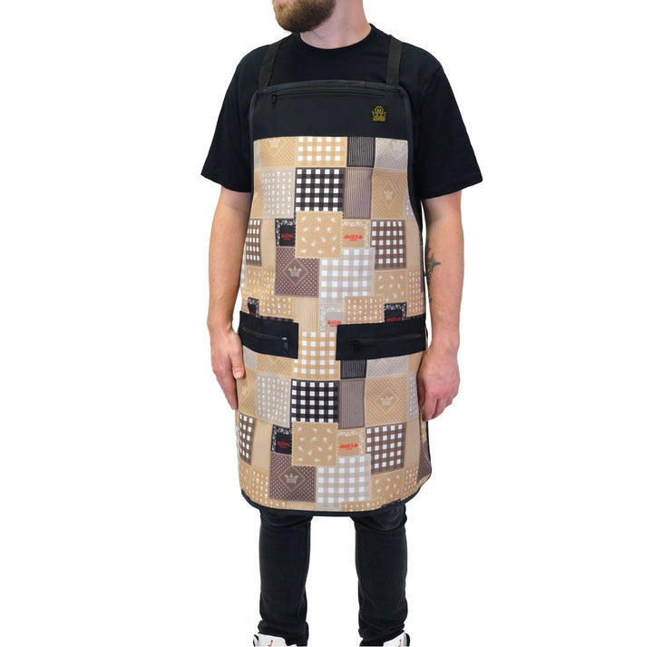 Person wearing a patchwork tan barber apron. 