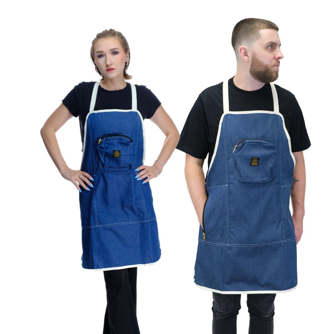 Two people wearing blue denim barber aprons on a white background