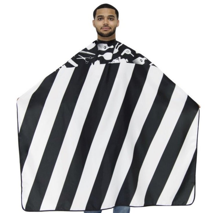 Man wearing a black and white striped barber cape on a white background