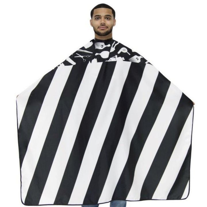Man wearing a black and white striped barber cape on a white background