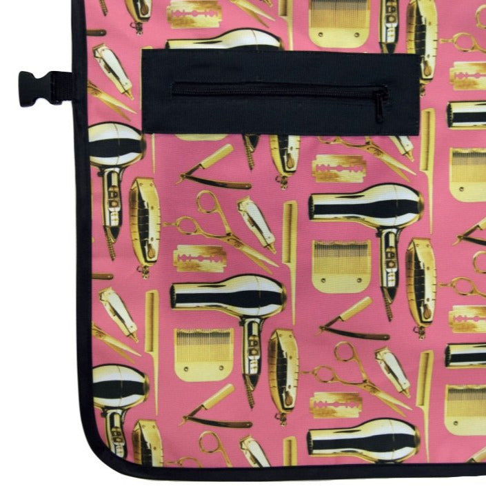 A pink barber apron with a barber pattern on a white background
