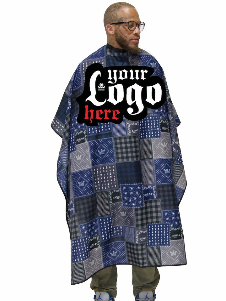 Man wearing a blue patchwork barber cape with a customizable logo area on a white background